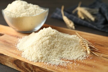 Pile of flour and spike on dark wooden table, closeup