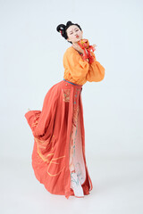 Beautiful dancers wearing ancient Tang Dynasty costumes and makeup performing classical dance