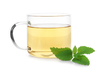 Aromatic lemon balm tea in glass cup and fresh leaves isolated on white