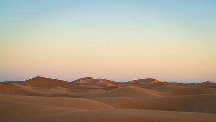 Fototapeta premium Serene Sunset over Rolling Sand Dunes A Desert Landscape Photography