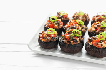 Delicious stuffed mushrooms on white wooden table, closeup. Space for text