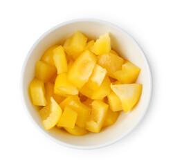Pieces of fresh yellow bell peppers in bowl isolated on white, top view