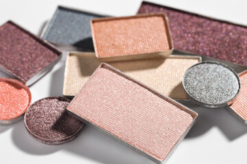 Beautiful eyeshadow refill pans on white background, closeup