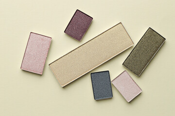 Beautiful eyeshadow refill pans on beige background, flat lay