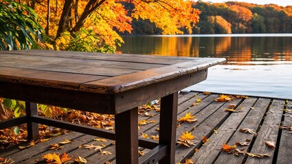 Naklejka premium A rustic table set by a lake surrounded by fall trees.