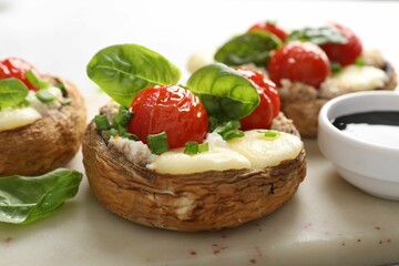 Tasty stuffed mushrooms served on light table, closeup