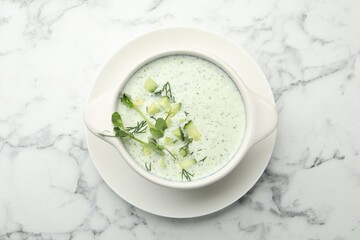 Tasty cucumber soup with dill and microgreens on white marble table, top view