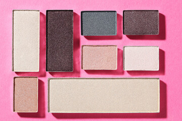 Fototapeta premium Beautiful eyeshadow refill pans on pink background, flat lay