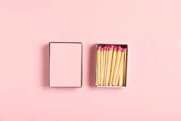 Matches and box on pink background, flat lay. Mockup for design