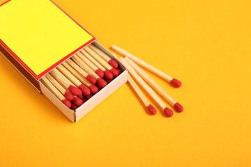 Matches and box on yellow background, closeup. Mockup for design