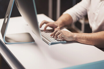Engaging in creative tasks at a modern workstation with sleek design and an inviting atmosphere in...