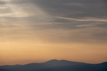 Colorful cloudy sky, toned effect photo background. Colorful cloudy sky at sunset, natural background photo. Cloudy sky at sunset. Sunset over the mountain.
