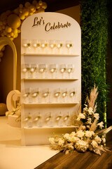 Celebratory display featuring glasses and floral arrangements at an event venue