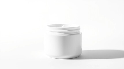 A white, cylindrical container with a slightly rounded bottom and a slightly raised lip around the opening. The container is empty and has a shadow cast on the white surface beneath it