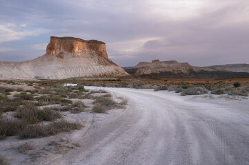 The Two Fangs of Bozhira, rock towers in the middle of the desert during sunrise in Mangystau,...