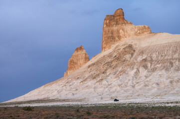 The Two Fangs of Bozhira, rock towers in the middle of the desert during sunrise in Mangystau,...