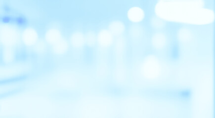 Blurred white hallway with light bokeh effect creating a clean abstract background.