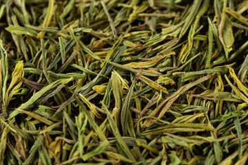 Dried green tea leaves texture background.