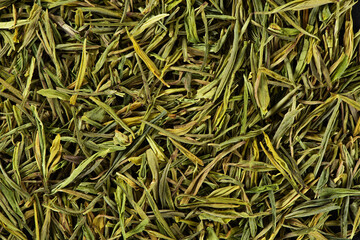 Dried green tea leaves texture background.