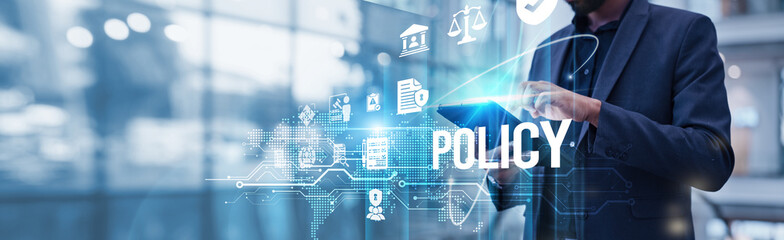 Businessman using tablet analyzing policy and economic growth strategies, market trends, government regulations, fiscal incentives, sustainability goals, and long-term development plans.