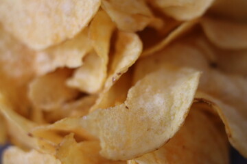 Crispy potato chips served in a close-up view showcasing texture and golden color on a casual snack table