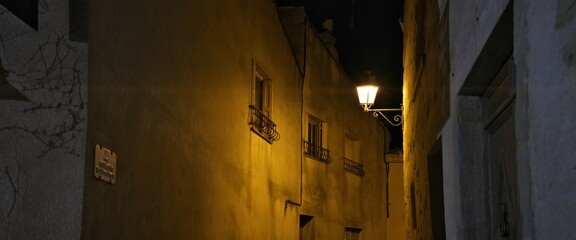 Carcassonne,France - May 15, 2025: Stone pavements and hotels in Carcassonne, fortified city, in France at night