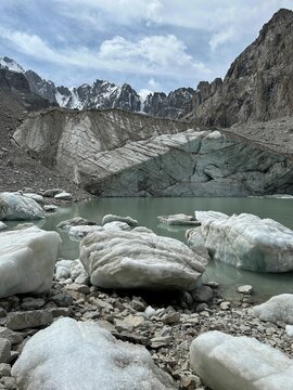 A glacier in the mountains. Kyrgyzstan, Ala Archa National Park. Uchitel glacier. Ice blocks lying in icy water, Glacier melting, glaciers disappearing, global warming, Switzerland, Tien Shan