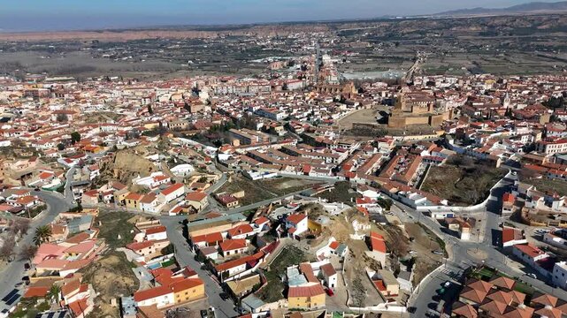 Drone flight above Guadix town with Cathedral of the Incarnation and Alcazaba Citadel in Spain