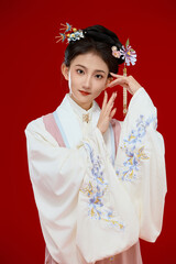Girl wearing Chinese Ming Dynasty Hanfu costume against a red background