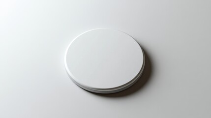Blank white round badge mockup on white surface