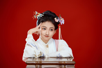 Girl wearing Chinese Ming Dynasty Hanfu costume against a red background