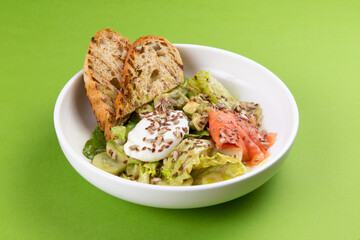 Salmon salad with poached egg.