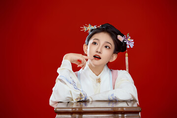 Girl wearing Chinese Ming Dynasty Hanfu costume against a red background
