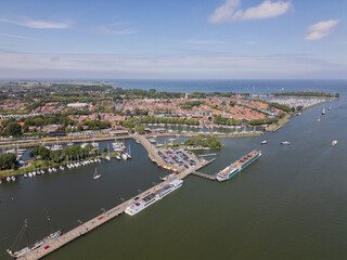 Aerial drone footage of historic picturesque Dutch city Enkhuizen with boats and yachts Netherlands harbor port water Ijsselmeer on sunny summer day