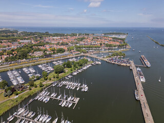 Aerial drone footage of historic picturesque Dutch city Enkhuizen with boats and yachts Netherlands harbor port water Ijsselmeer on sunny summer day