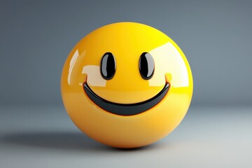 Fototapeta premium Glossy yellow emoticon ball with smiling face on gray background. Perfect for illustrating happiness, positivity, or simple communication.