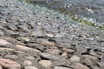 stone embankment of the river and water