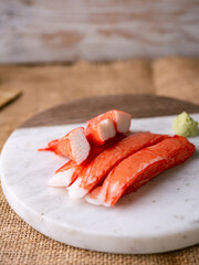 Fresh crab sticks surimi set on white plate with wasibi.