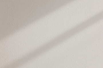 Neutral textured wall with soft shadows creating a simple backdrop