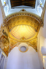 Gold-colored decorations on an ancient wall, medieval synagogue Santa Maria La Blanca, Toledo, Spain