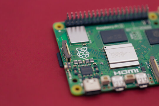 Mnichovo Hradiste, Czechia &ndash; May 31 2025: Close-up detail of Raspberry Pi 5 on red background