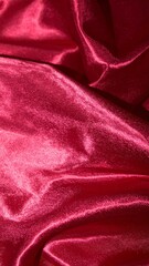 Obraz premium Dark red glossy silk cloth texture close view background