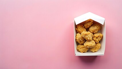 Crispy golden chicken popcorn in a white takeout box on pink background