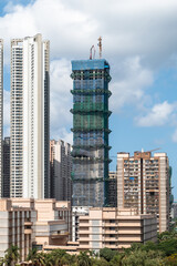 Mumbai skyline showcasing a high-rise building under construction amid urban development activity