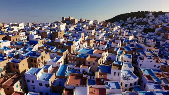 Vibrant Blue Rooftops of Chefchaouen, Morocco with Morning Light and Urban Texture