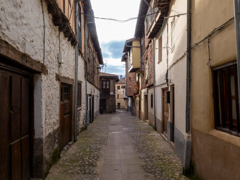 Cobblestone alley winding through charming historic village in spain