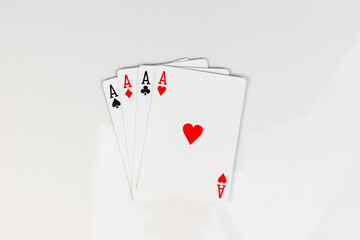 Four aces playing cards of spades, diamonds, clubs and hearts on white background