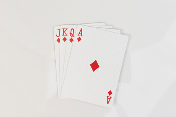 Royal flush in diamonds. Playing cards spread on white background