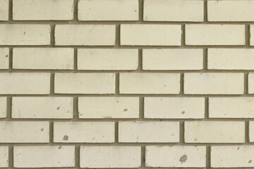 White brick wall, background. Light dirty brick, fence. Close-up of white brick exterior wall. Construction, building, close-up of house element