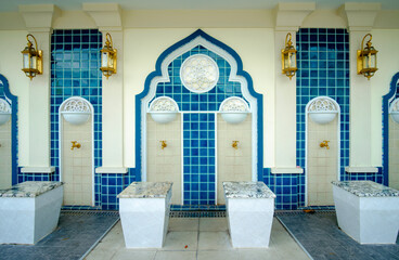 Modern Islamic wudu area with clean water basins and tiles